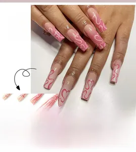 Detail of long ballerina press-on nails with pink ombre, heart motifs and abstract line art
