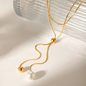 Long adjustable gold snake chain necklace with pearl tassel in elegant Y-shape style