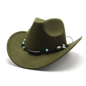 Detail of dark green wool felt cowboy hat with bohemian turquoise and shell decorative band