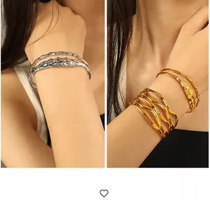 Detailed view of gold and silver plated titanium steel bracelets with irregular lava texture