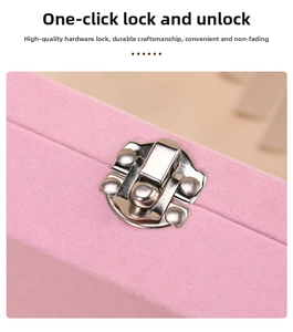 Detail of pink velvet jewelry box showing silver metal clasp with one-press closure