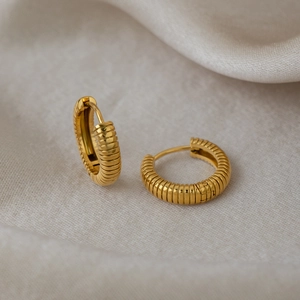 Polished 18K gold plated hoop earrings with striped texture on silk fabric