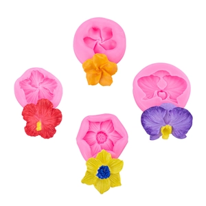 Pink silicone flower molds with colorful finished resin floral shapes on white background