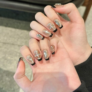 French black gold cat-eye press-on nails with glitter, pearls and cross charms