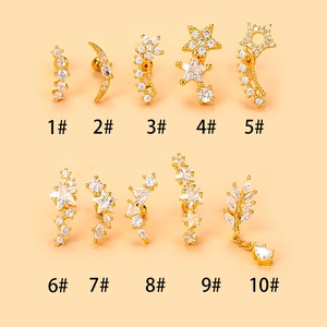 Macro view of gold stainless steel stud earrings with star moon zircon inlays