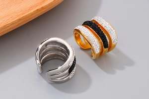 Close-up of geometric multi-layer ring with black and white rhinestones in gold and silver