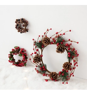 Macro detail of Christmas candle rings with red berries pine cones and artificial snow