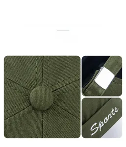 Detail of olive green docker hat with white Sports embroidery and metal buckle closure