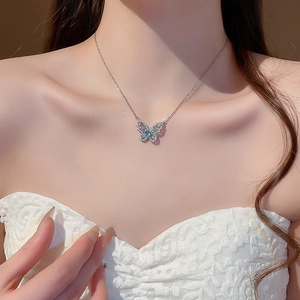 Detailed view of silver butterfly pendant featuring blue opal and sparkling zircon stones