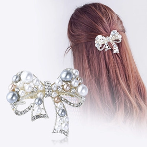 Close-up of a Korean style butterfly hair clip with grey champagne pearls and rhinestones