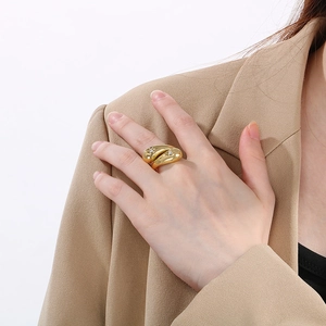 Close-up of gold irregular crossover ring with rhinestones on female model hand