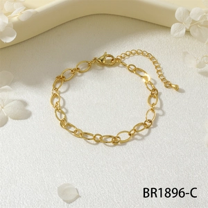 Dettaglio di un bracciale a catena a maglie dorate con chiusura a moschettone e catenella