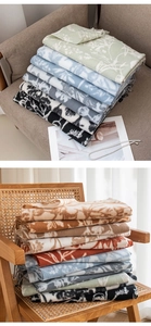Detailed view of folded faux cashmere scarves with floral prints in multiple colors