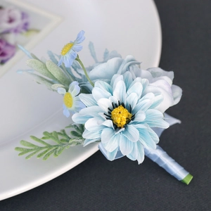 Light blue artificial boutonniere with cosmos flowers and satin ribbon for wedding suit