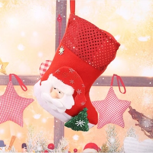 Close-up of red sequined Christmas stocking featuring 3D Santa and green tree decor