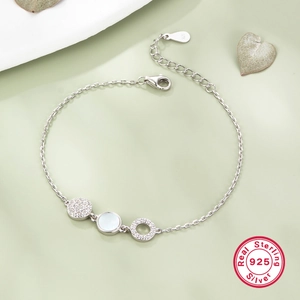 Macro view of S925 sterling silver bracelet with circular shells and diamond pendants
