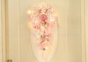 Close-up of pink Christmas teardrop swag with LED lights and Merry Christmas plaque