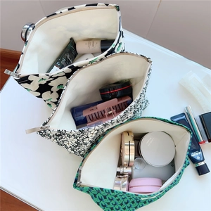 Three vintage floral and geometric canvas makeup bags with metal zipper for cosmetic storage