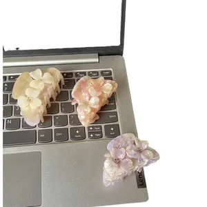 Set of three elegant flower hair claws in beige, pink, and purple with pearl luster