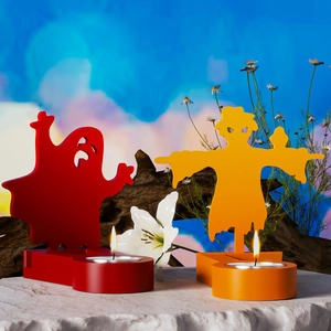 Ghost and scarecrow candle holders with burning tealights on a rustic stone base