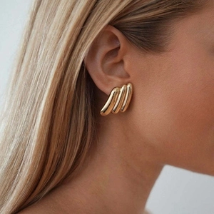 Minimalist 18K gold stainless steel wave rib earrings shown on model for elegant look