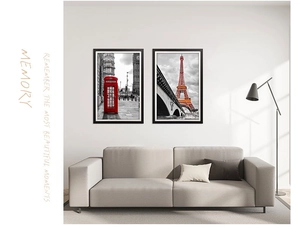 Detail of two black framed wall art prints featuring London and Paris landmarks