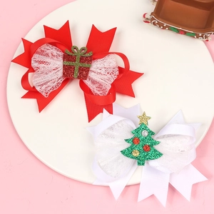 Close-up of festive Christmas bow clips with glittery gift box and tree ornaments