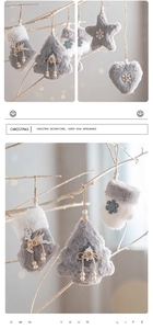 Close-up of Nordic plush Christmas ornaments with wood buttons on tree branches