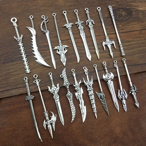 Detailed close-up of antique silver alloy sword and weapon charms for DIY crafting