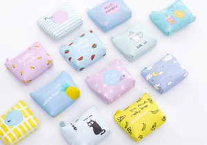 Close-up of cute cartoon PU leather coin purses with colorful patterns and zip closure