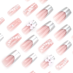 Sweet pink press-on nails with 3D bows, silver French tips, and pearl accents