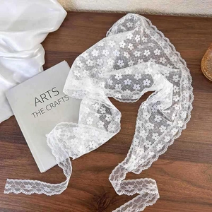 Elegant white lace floral waist scarf and headband accessory on a vintage wooden background