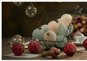 Macro view of colorful glass Christmas ornaments with golden glitter and varied shapes