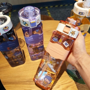 Detail of square plastic water bottles with colorful silicone sleeves and 3D stickers