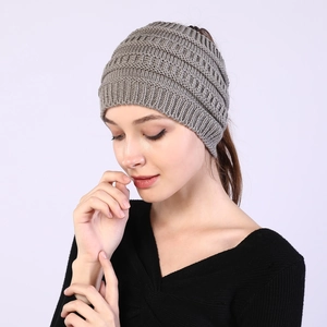 Detail of grey knitted ponytail headband showing the warm ribbed texture and top opening