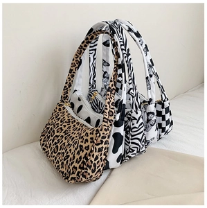 Detail of five stylish underarm bags featuring leopard, cow, zebra, and checkerboard patterns