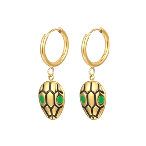 Golden snake head hoop earrings with green eyes and black scale details on white background