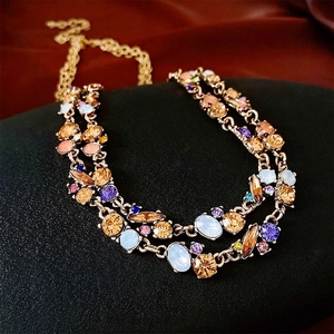 Double-layered gold necklace with colorful geometric crystals in a luxury French style