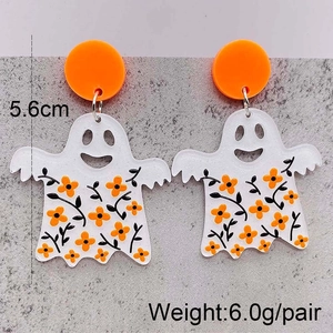 Halloween acrylic earrings featuring orange studs and white floral ghosts on stone surface