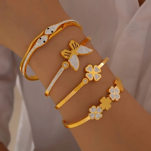 Elegant gold plated titanium steel bangles with clover, heart, and butterfly diamond accents