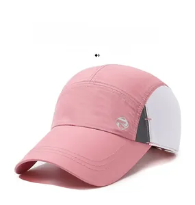 Close-up of pink quick-dry baseball cap with white mesh panels and silver geometric logo