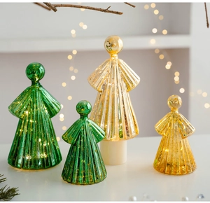 Close-up of glass angel ornaments with LED lights, green and gold metallic rib texture