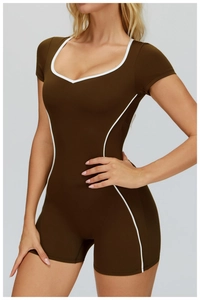 Detail of dark brown bodysuit with white piping and u-shaped neckline for fitness