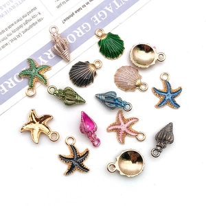 Flat lay of colorful enamel sea shell and starfish charms for DIY jewelry making kits