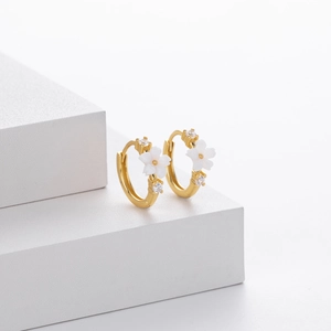 Elegant gold flower hoop earrings with white petals and crystals on geometric stands
