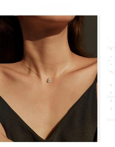 Detail of pear-cut moissanite pendant on invisible fishing line choker necklace