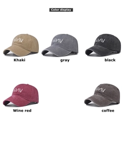 Detail view of washed cotton baseball caps in khaki, gray, black, wine red, and coffee