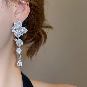 Close-up of elegant silver tassel earrings with sparkling zircon petals and water drops