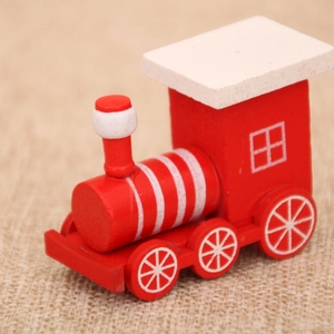 Macro side view of a red wooden Christmas train engine on a rustic burlap background