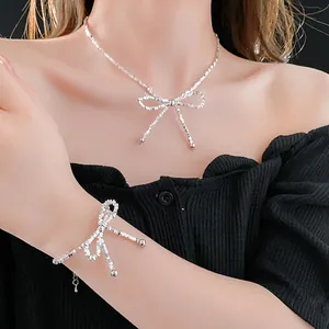 Silver bowknot jewelry set featuring a delicate necklace and bracelet with zircon accents